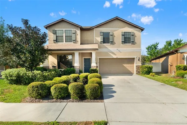 a front view of a house with a yard and garage