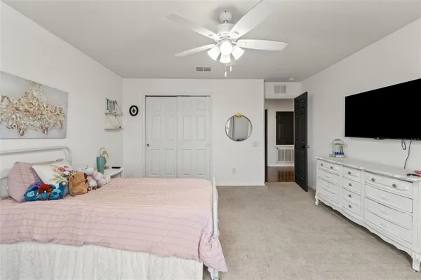 a spacious bedroom with a bed and large window