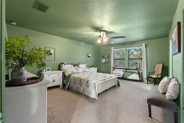 a bedroom with a bed couch and window