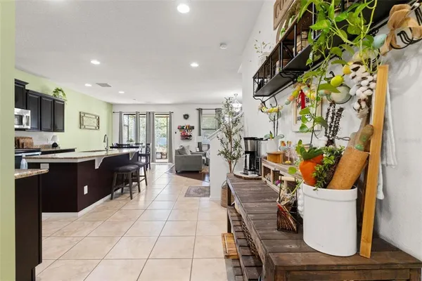 a dining room with furniture and large windows