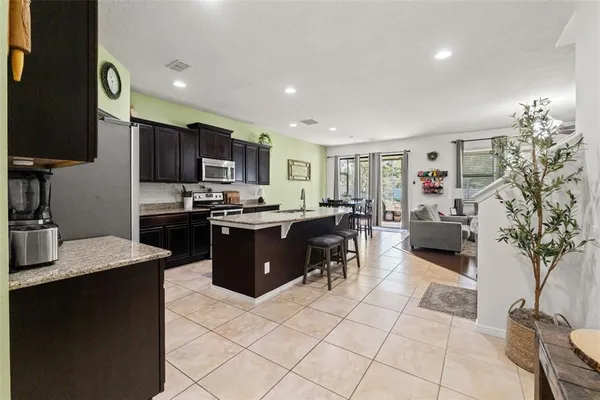 a living room with furniture flat screen tv and a large window