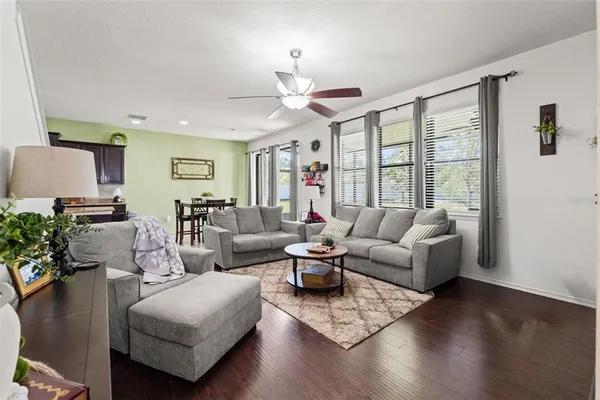 a living room with furniture and wooden floor