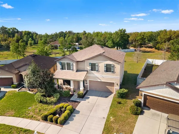 a front view of house with yard and outdoor seating