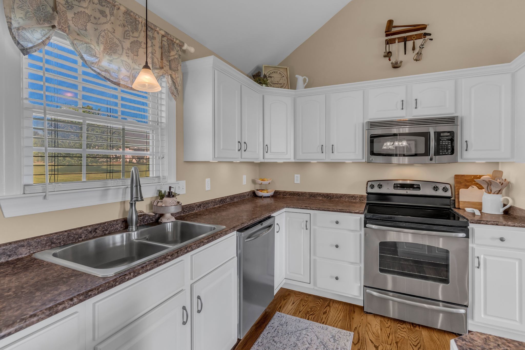 1688 Porter Road Bon Aqua, TN 37025 - Photo 11 of 38 a kitchen with granite countertop a sink stainless steel appliances and cabinets