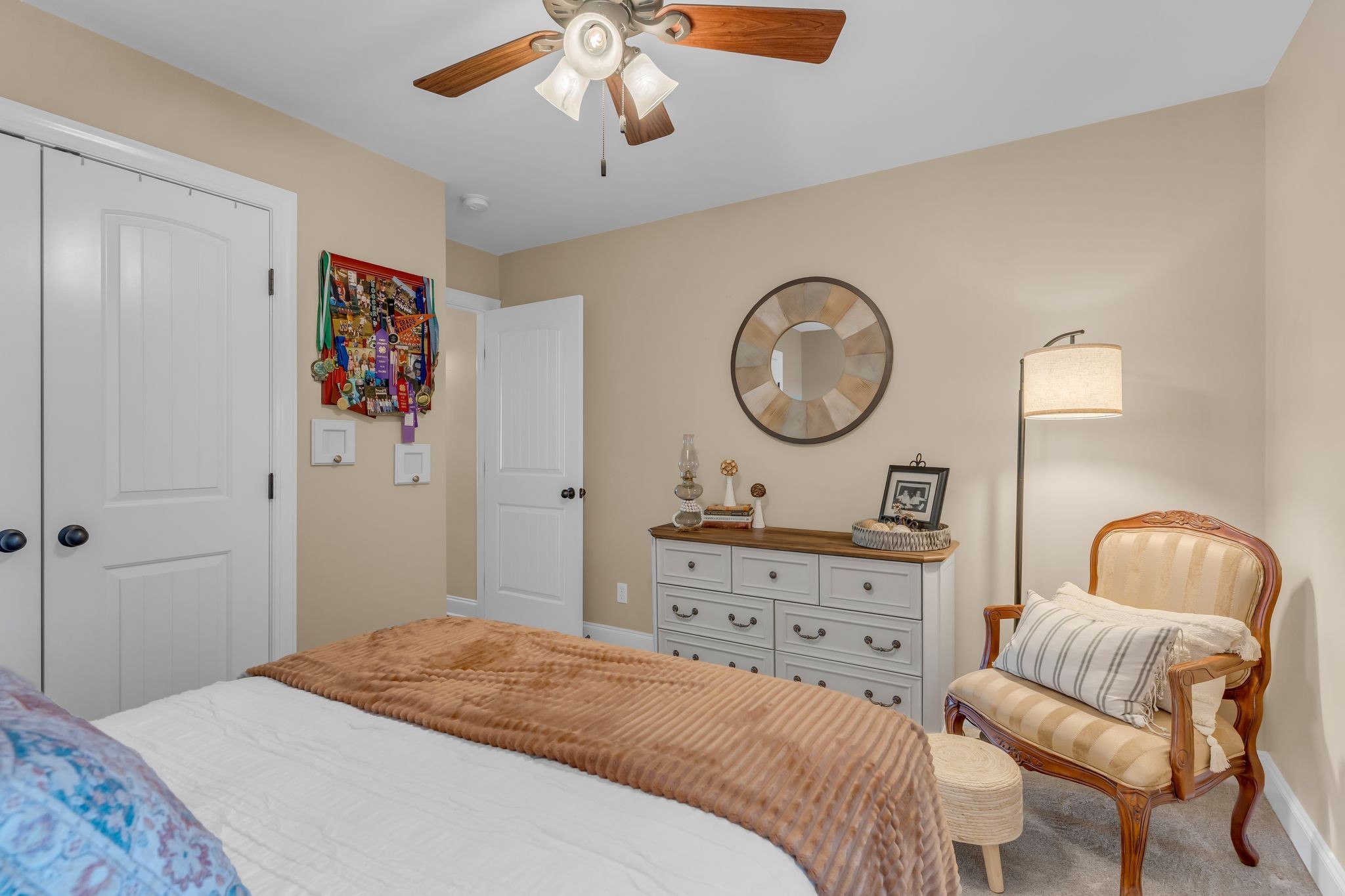1688 Porter Road Bon Aqua, TN 37025 - Photo 15 of 38 a bedroom with a bed and a chandelier