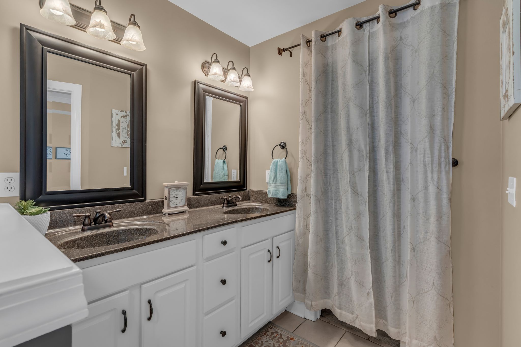 1688 Porter Road Bon Aqua, TN 37025 - Photo 22 of 38 a bathroom with a double vanity sink and a mirror