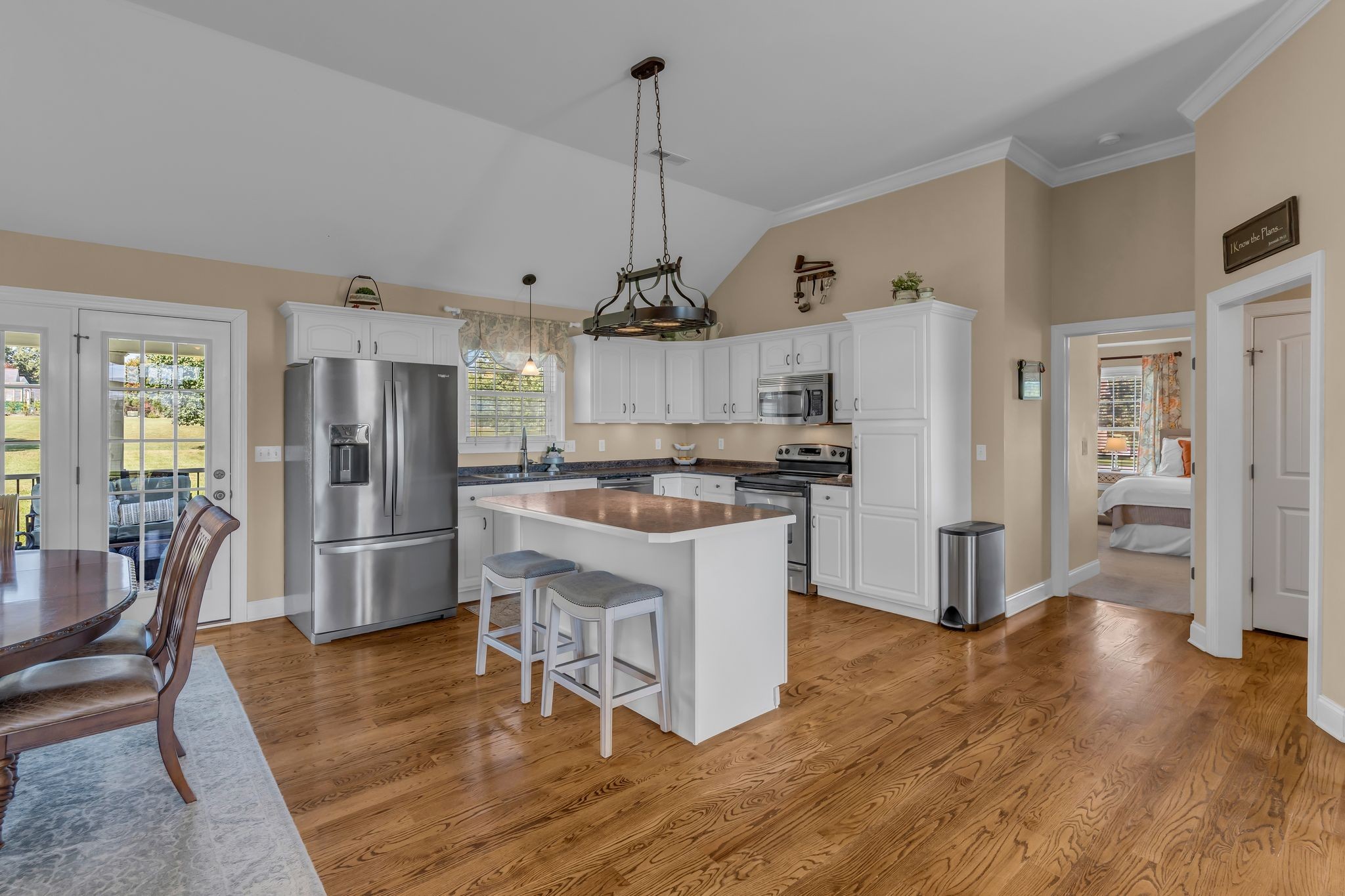 1688 Porter Road Bon Aqua, TN 37025 - Photo 8 of 38 a kitchen with stainless steel appliances granite countertop a refrigerator a stove top oven a sink dishwasher and a dining table with wooden floor