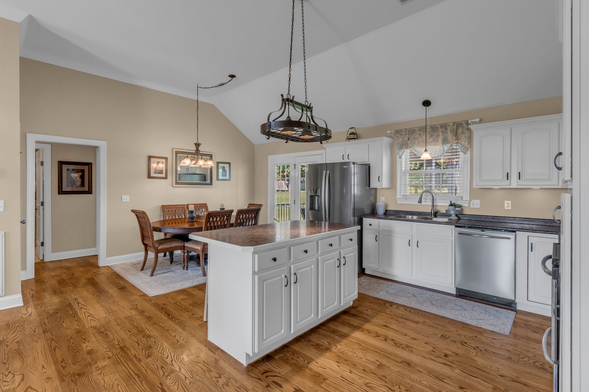 1688 Porter Road Bon Aqua, TN 37025 - Photo 9 of 38 a kitchen with granite countertop white cabinets and stainless steel appliances