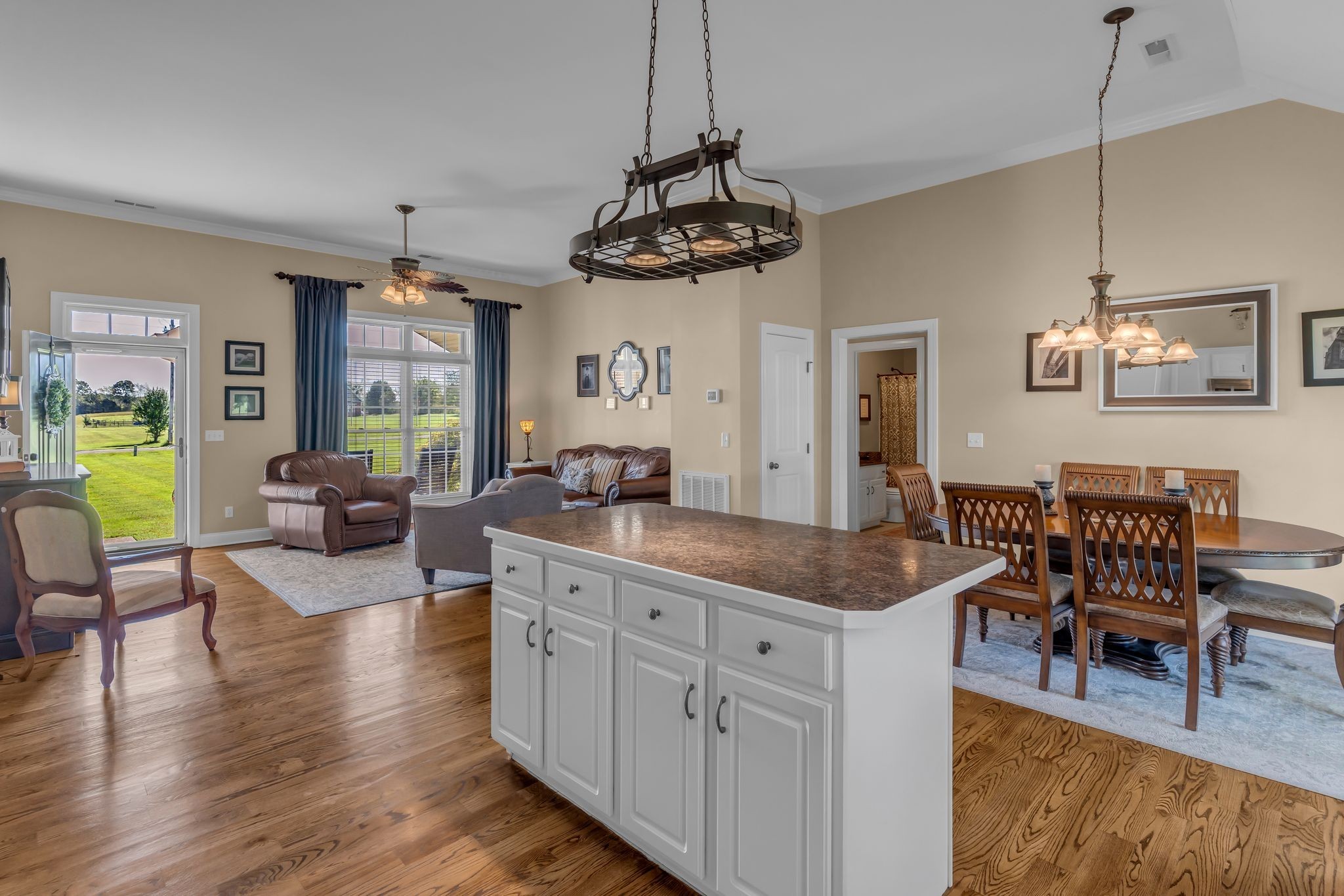 1688 Porter Road Bon Aqua, TN 37025 - Photo 10 of 38 a living room with stainless steel appliances granite countertop furniture wooden floor and a chandelier