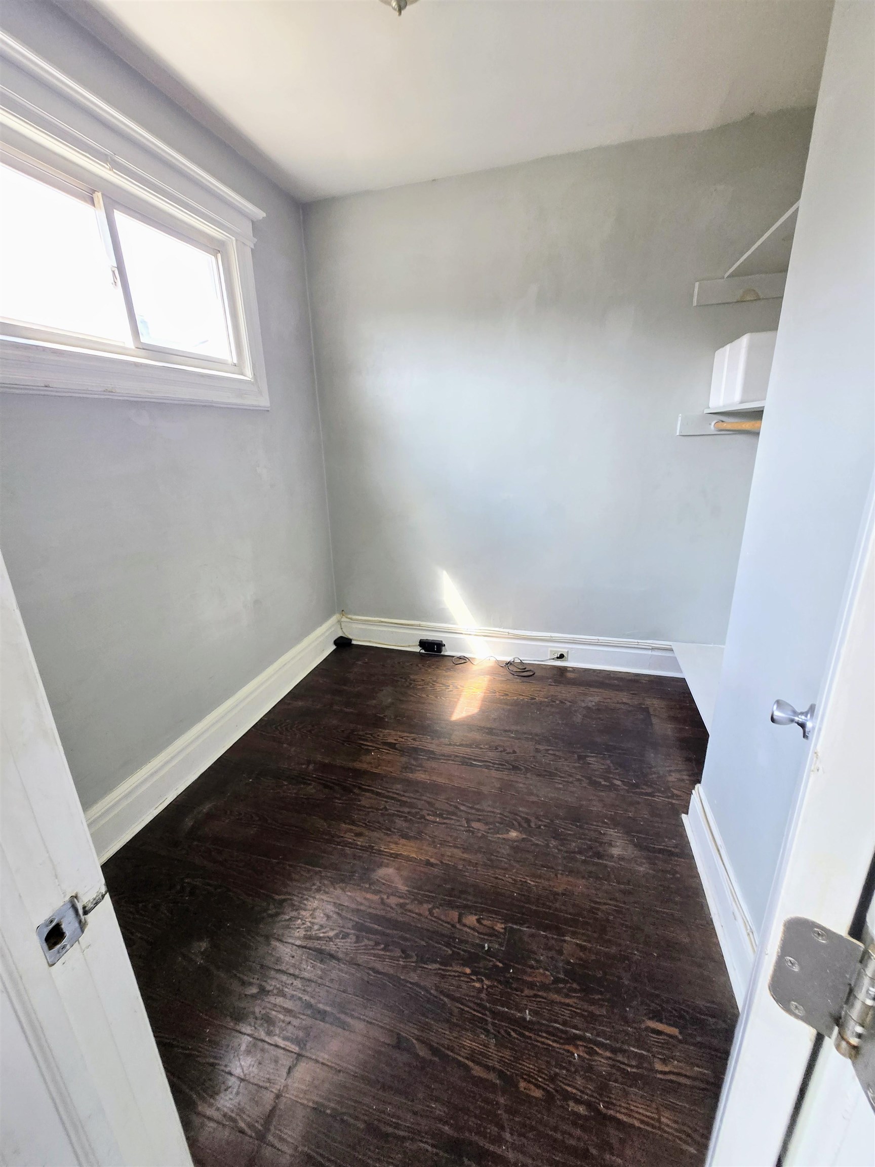 316 Devon Street, Unit 2 Kearny, NJ 07032 - Photo 6 of 9 an empty room with wooden floor and windows