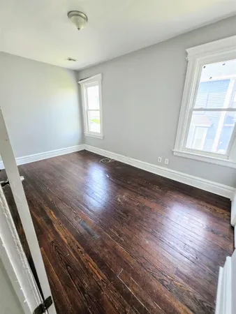a bathroom with a tub a sink and a large mirror next to a window