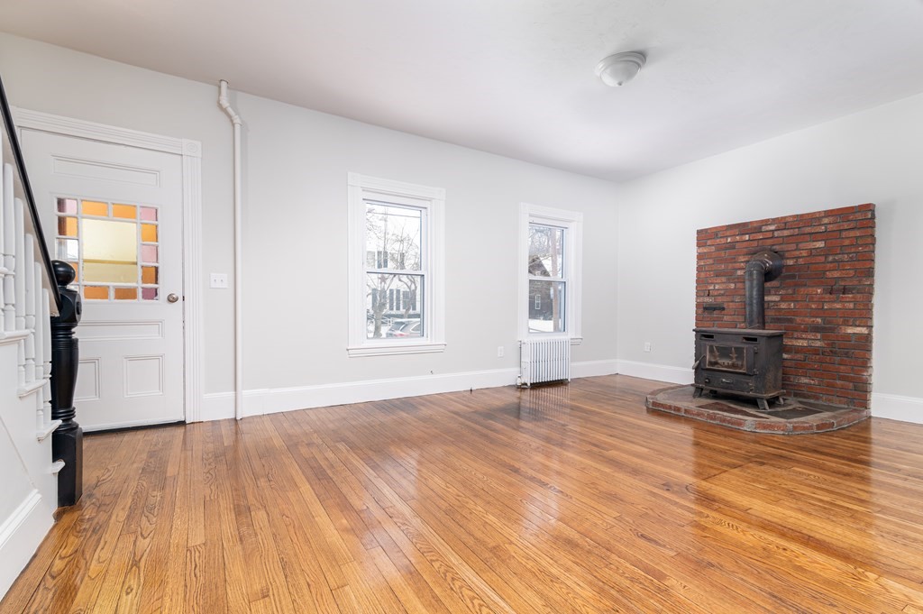 36 Cherry Street Whitman, MA 02382 - Photo 5 of 35 wooden floor in an empty room with a fireplace