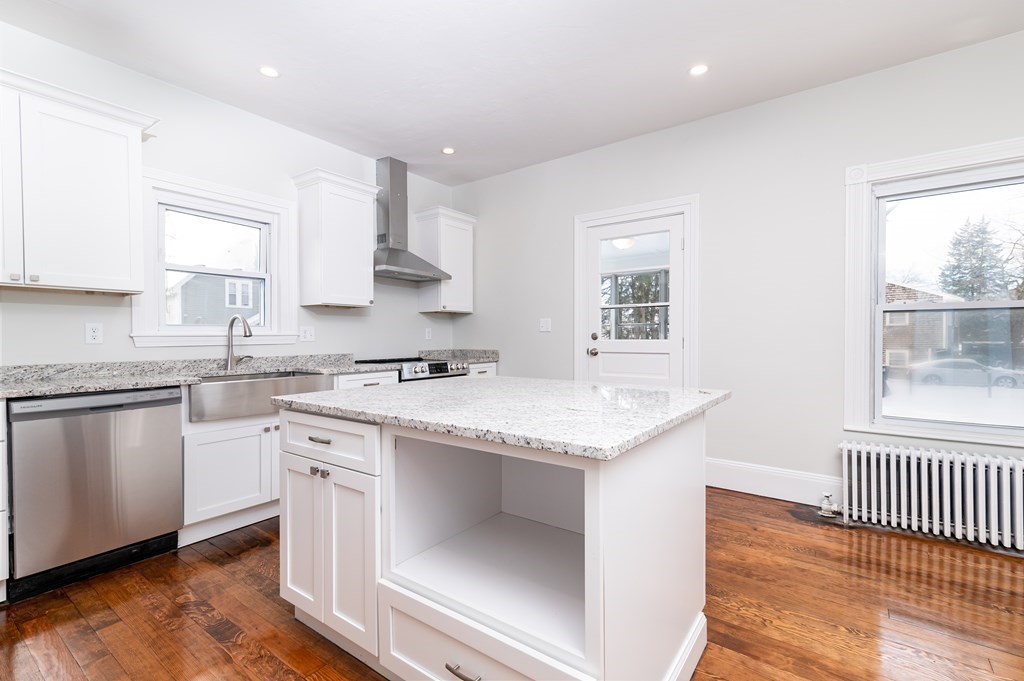 36 Cherry Street Whitman, MA 02382 - Photo 9 of 35 a kitchen with granite countertop white cabinets and white appliances