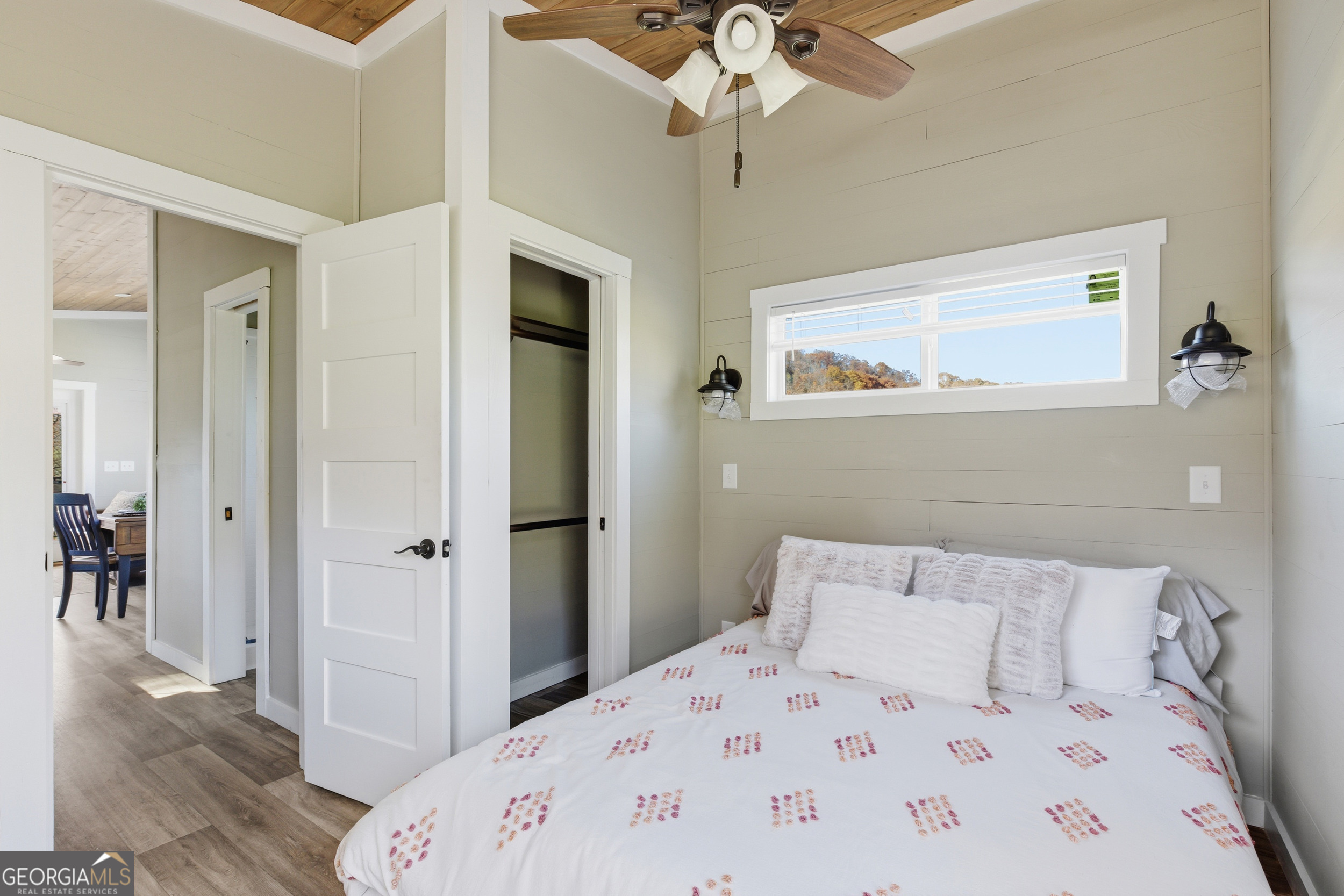 527 Saunders Road Franklin, NC 28734 - Photo 15 of 16 a bedroom with a bed and a chandelier