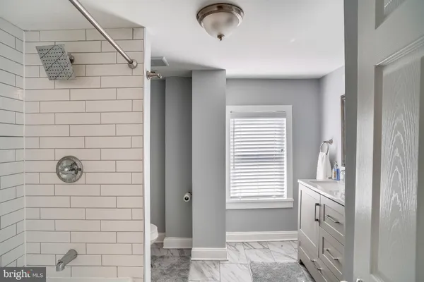 a bathroom with a tub and a shower