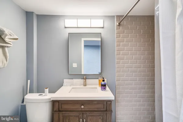 a bathroom with a sink a toilet and mirror