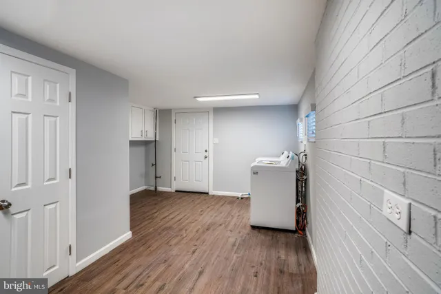 a view of a utility room with wooden floor