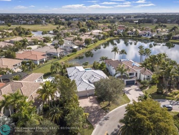 an aerial view of lake and residential houses with outdoor space