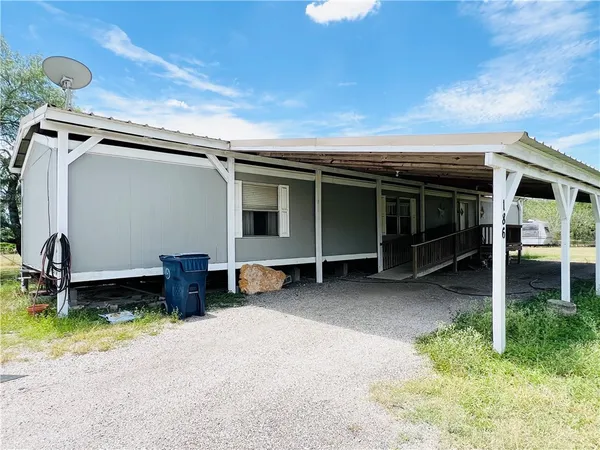 a view of a backyard with furniture and a tub