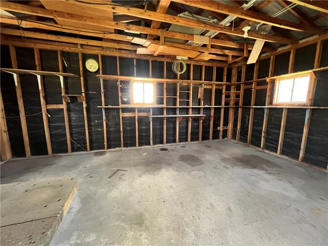a view of an empty room with wooden walls