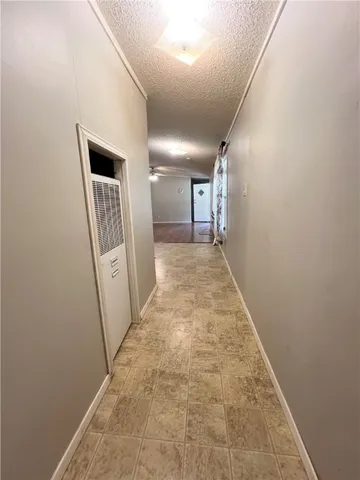 a living room with stainless steel appliances furniture a fireplace and a flat screen tv
