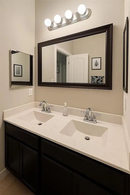4420 Red River Street, Unit B Austin, TX 78751 - Photo 8 of 11 A well-lit vanity with dual sinks, framed mirrors, and ample countertop space.