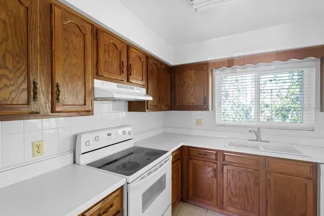 a kitchen with cabinets a window and sink