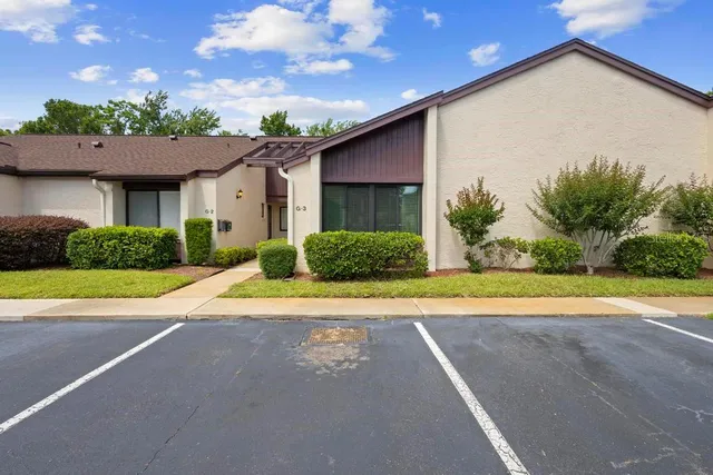a view of a house with a backyard and a garage