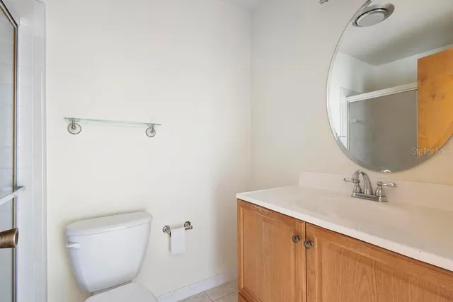 a bathroom with a sink mirror and toilet