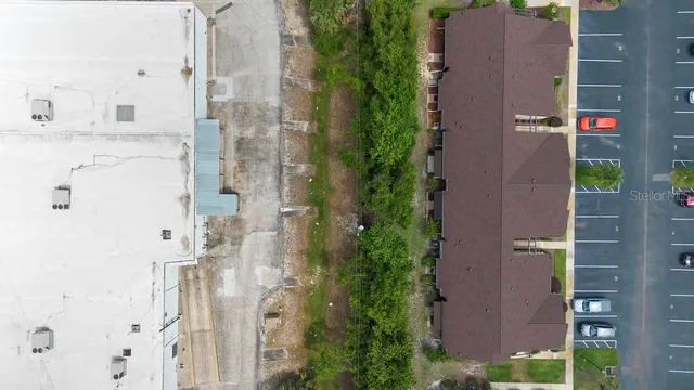 aerial view of a house with outdoor space and street view