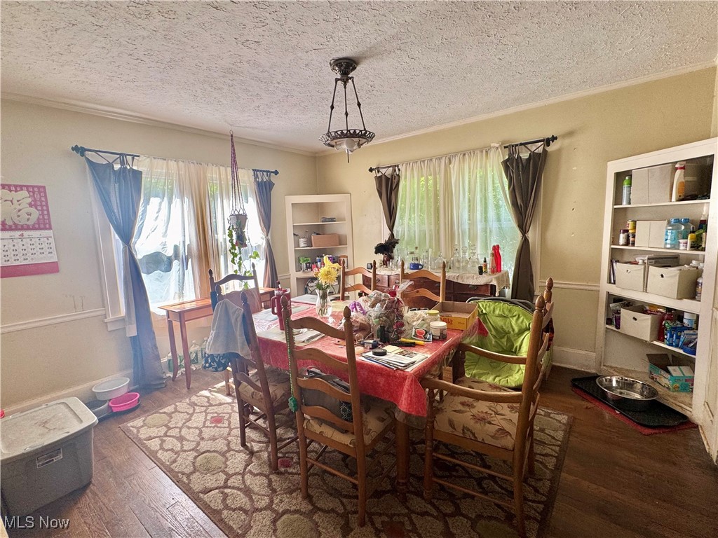 4406 Bayard Road Cleveland, OH 44121 - Photo 4 of 10 Dining room featuring wood finished floors and a textured ceiling