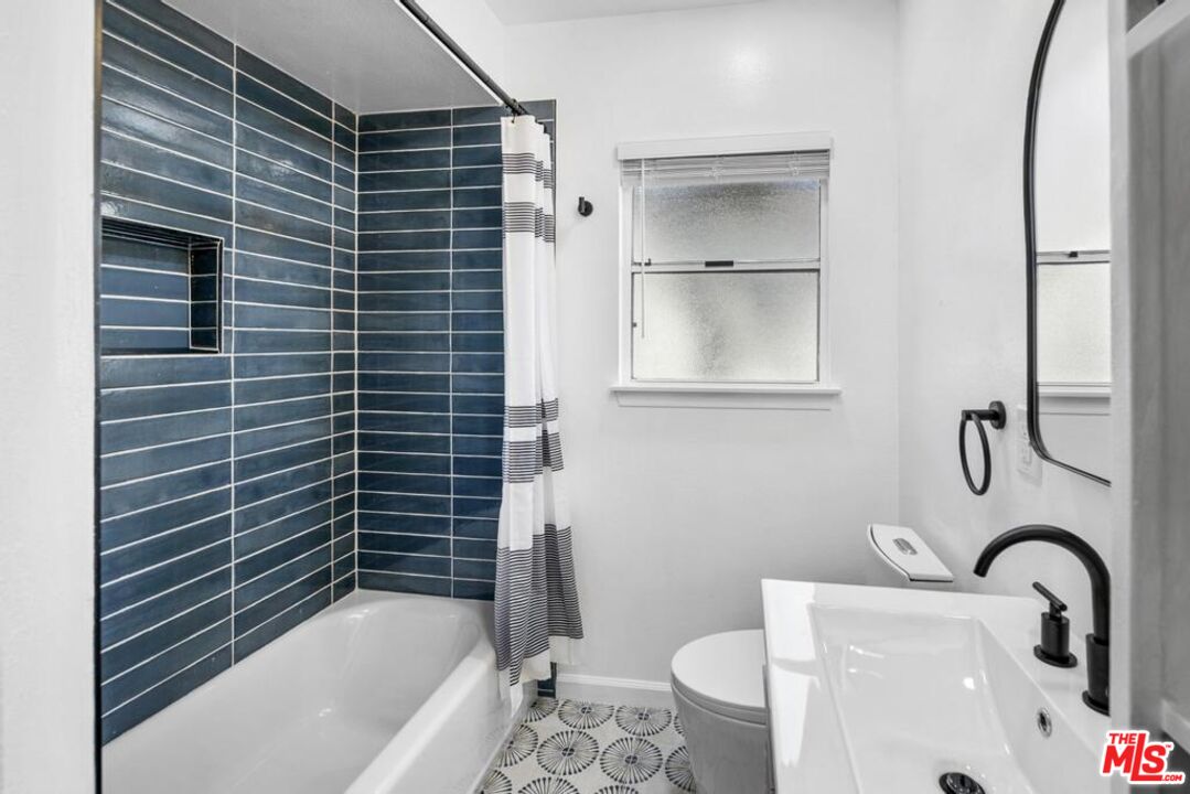 5825 Bowcroft Street, Unit 1 Los Angeles, CA 90016 - Photo 11 of 20 a bathroom with a sink toilet and shower