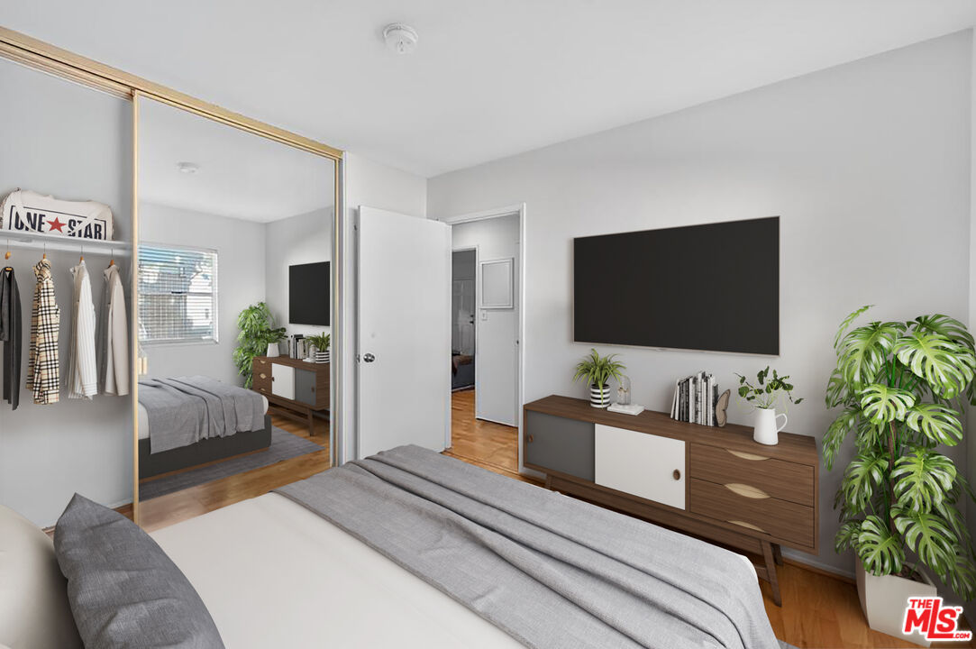 5825 Bowcroft Street, Unit 1 Los Angeles, CA 90016 - Photo 12 of 20 a bedroom with a bed and a flat screen tv