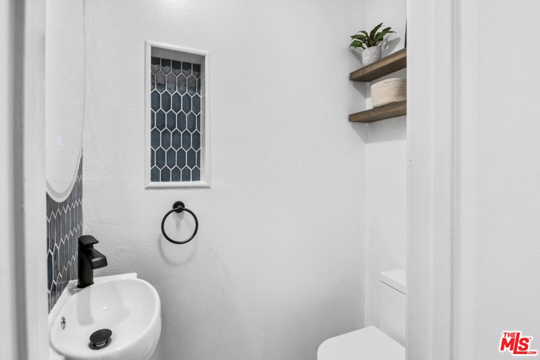 5825 Bowcroft Street, Unit 1 Los Angeles, CA 90016 - Photo 14 of 20 a bathroom with a sink toilet and mirror