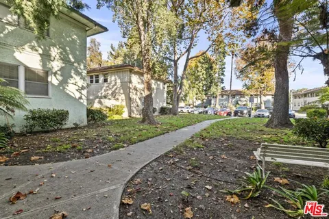 a view of garage with a large tree
