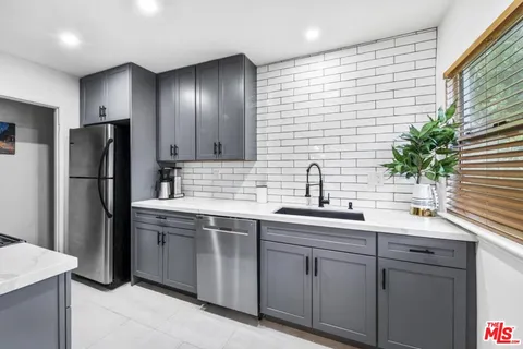 a kitchen with a sink and refrigerator