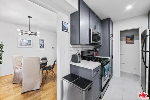 a kitchen that has a sink stainless steel appliances a counter space and cabinets