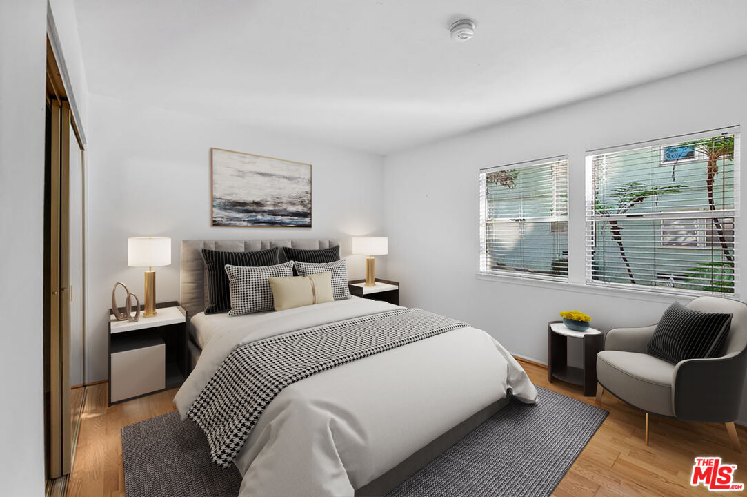 5825 Bowcroft Street, Unit 1 Los Angeles, CA 90016 - Photo 9 of 20 a bedroom with a bed couch and a large window