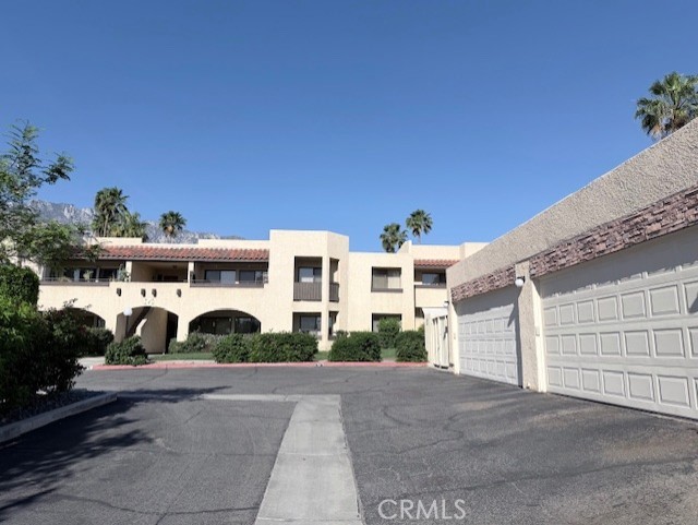 200 East Racquet Club Road, Unit 35 Palm Springs, CA 92262 - Photo 8 of 8 a view of a white house with a yard and plants