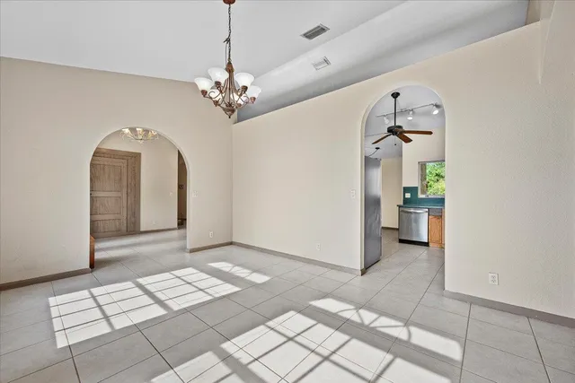 a view of an empty room with a fireplace and a window