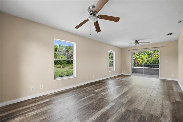a view of a porch with chairs and backyard