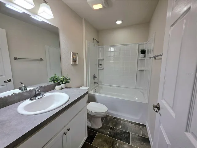 a bathroom with a sink toilet tub and shower