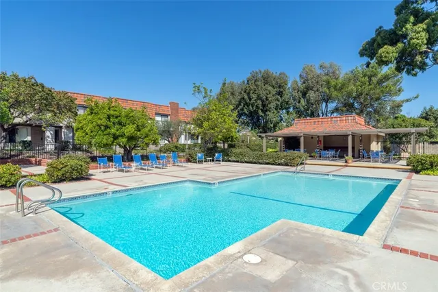 a view of house with swimming pool outdoor seating