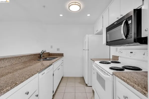a kitchen with a sink stove and microwave
