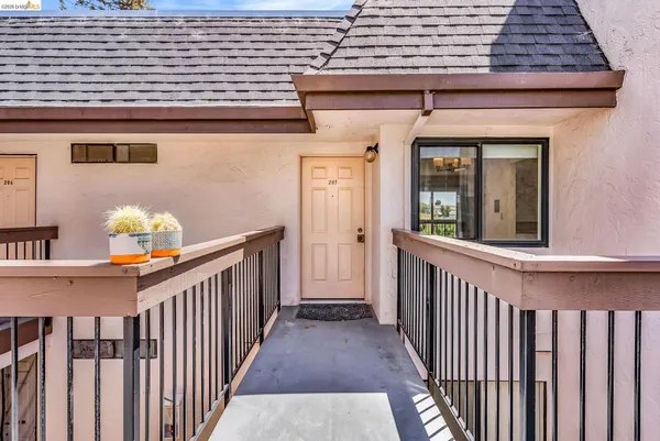 a view of a porch with wooden floor and fence