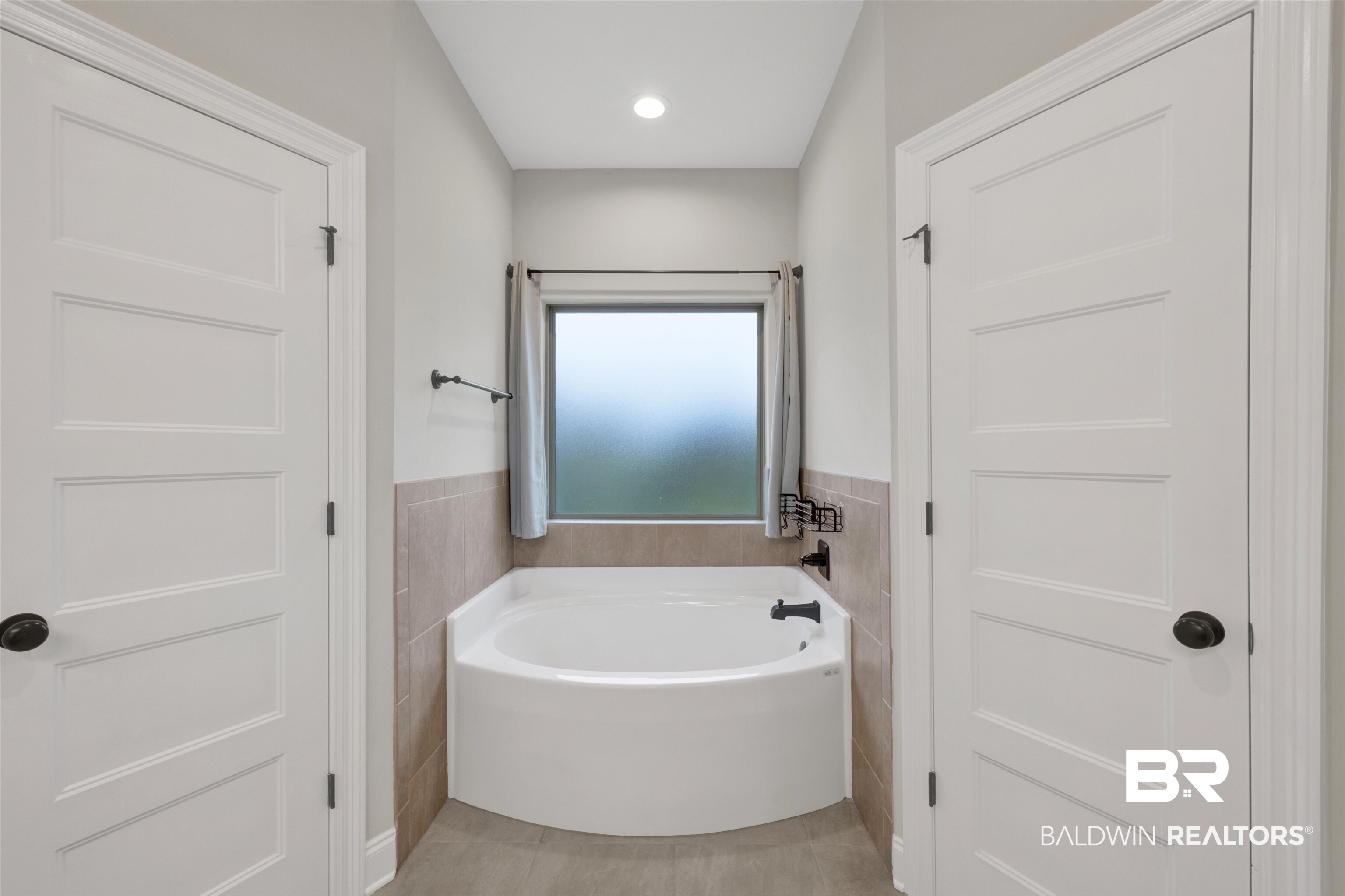 12672 Squirrel Drive Daphne, AL 36527 - Photo 24 of 49 Soaking tub with tiled surround, frosted window, and recessed lighting