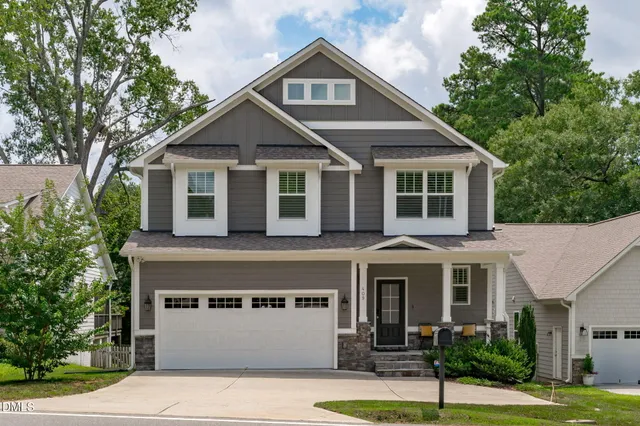 a front view of a house with a yard garage and outdoor seating