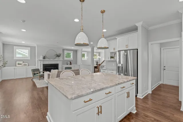 a view of living room and kitchen with furniture wooden floor