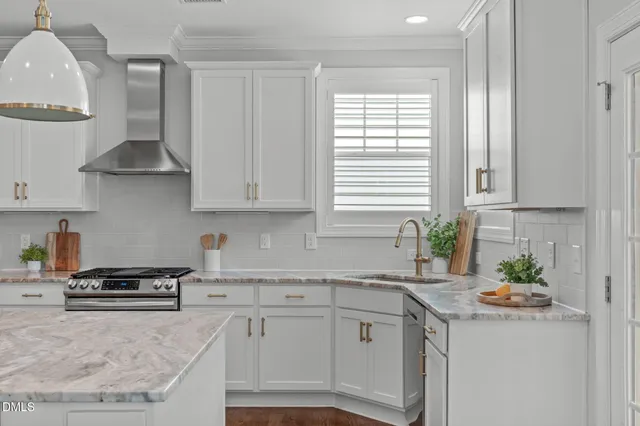 a kitchen with stainless steel appliances granite countertop a sink a stove and a window