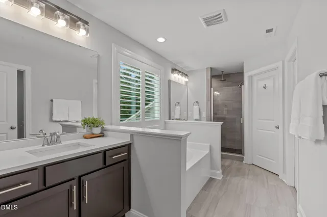 a bathroom with a sink double vanity and a mirror